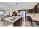 Stylish kitchen with granite counters, stainless steel appliances, and a large island with seating at 10808 Salida St, Commerce City, CO 80022