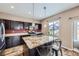 This kitchen features a granite island, wooden floors, stainless steel appliances, and dark wooden cabinets at 10808 Salida St, Commerce City, CO 80022