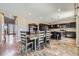Spacious kitchen and dining area with dark cabinets, stainless appliances, and hardwood floors at 10808 Salida St, Commerce City, CO 80022