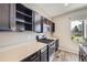 Well-appointed kitchen featuring dark cabinetry, stainless steel appliances, and modern fixtures at 10808 Salida St, Commerce City, CO 80022