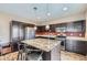 Kitchen featuring granite countertops, stainless steel appliances, and dark cabinets at 10808 Salida St, Commerce City, CO 80022