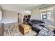 Comfortable living room with hardwood floors, a plush leather sofa, and views of the outdoors at 10808 Salida St, Commerce City, CO 80022