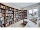 The living room features floor-to-ceiling bookshelves lining the wall and a comfortable sectional sofa at 10808 Salida St, Commerce City, CO 80022