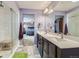 A well-lit main bathroom features a glass shower and access to the main bedroom at 10808 Salida St, Commerce City, CO 80022