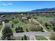 Stunning aerial view of a peaceful neighborhood surrounded by green spaces and mountains, showcasing community living at 18045 Sunburst Dr, Monument, CO 80132