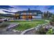 Beautiful backyard featuring a well-manicured lawn, lush landscaping, and a cozy outdoor sitting area at 18045 Sunburst Dr, Monument, CO 80132