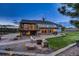 Outdoor living space with a fire pit, patio, and deck perfect for entertaining or relaxing in the backyard at 18045 Sunburst Dr, Monument, CO 80132