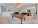 Spacious finished basement with a pool table, piano and comfortable seating for entertaining at 18045 Sunburst Dr, Monument, CO 80132