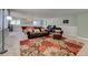Open basement featuring a leather sofa, a pool table and an area rug with an orange and brown floral pattern at 18045 Sunburst Dr, Monument, CO 80132
