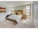 Bright and airy bedroom with a large bed, soft colors, and natural light from the windows at 18045 Sunburst Dr, Monument, CO 80132