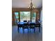 Dining area featuring a wooden table with views of an outdoor deck and wooded landscape at 18045 Sunburst Dr, Monument, CO 80132