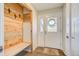 Charming entryway with wood accents, a convenient built-in bench, and a welcoming 'Welcome' mat at 18045 Sunburst Dr, Monument, CO 80132