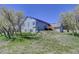 Two-story home with a charming deck and a well-maintained yard featuring mature trees on a sunny day at 18045 Sunburst Dr, Monument, CO 80132