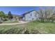 Exterior view of a home with a stone and siding and back patio with a mountain view, offering space for outdoor living at 18045 Sunburst Dr, Monument, CO 80132