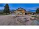 Charming home featuring a spacious garage, deck, and landscaped yard with stone accents under a twilight sky at 18045 Sunburst Dr, Monument, CO 80132