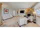 Bright living room features a stone fireplace, wood paneling, and a cozy seating arrangement at 18045 Sunburst Dr, Monument, CO 80132