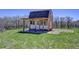 Charming outbuilding features a porch, white trim, and a cozy interior, ideal for a studio or workshop at 18045 Sunburst Dr, Monument, CO 80132