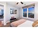 Serene bedroom with city views, a cozy bench, and ample natural light at 2240 N Clay St # 501, Denver, CO 80211