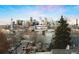 Breathtaking downtown city view showcasing the skyline over neighborhood buildings and tree lined street at 2240 N Clay St # 501, Denver, CO 80211