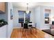 Cozy dining area with a round table, chandelier, and large window offering city views at 2240 N Clay St # 501, Denver, CO 80211