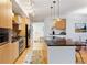 Open kitchen with stainless steel appliances, hardwood flooring, and seamless connection to living spaces at 2240 N Clay St # 501, Denver, CO 80211