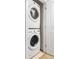 Stacked washer and dryer in laundry area provides space saving in condo unit at 2240 N Clay St # 501, Denver, CO 80211
