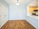 Bright dining room with hardwood floors and an open kitchen view, offering a spacious and modern living experience at 2809 Syracuse Ct # 129, Denver, CO 80238