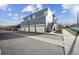 Exterior view of the townhome showcasing garages, parking, and stairs at 2809 Syracuse Ct # 129, Denver, CO 80238