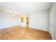 Open living room with wood floors, seamlessly connecting to the kitchen through a serving hatch at 2809 Syracuse Ct # 129, Denver, CO 80238