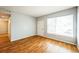 Bright living room with wood floors, large window, and neutral paint, creating a welcoming atmosphere at 2809 Syracuse Ct # 129, Denver, CO 80238
