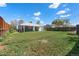 Spacious backyard with a covered patio and mature landscaping at 2205 S Irving St, Denver, CO 80219