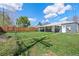 Fenced backyard with a covered patio extending from the house at 2205 S Irving St, Denver, CO 80219
