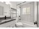 Modern bathroom featuring marble-look tile, bathtub, and sleek fixtures at 2205 S Irving St, Denver, CO 80219