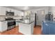 Well-equipped kitchen featuring stainless steel appliances, granite countertops, and a center island at 2205 S Irving St, Denver, CO 80219