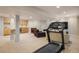Finished basement with a treadmill and open layout, with a wet bar and media space in the background at 1009 Monarch Way, Superior, CO 80027