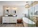 Luxurious bathroom with dual sinks, a freestanding tub, glass-enclosed shower, and modern fixtures at 1009 Monarch Way, Superior, CO 80027