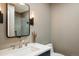Stylish powder room with modern fixtures, wallpapered accent wall, and a sleek vanity at 1009 Monarch Way, Superior, CO 80027