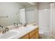 Bright bathroom with double sinks, large mirror, and tiled shower and bath at 1009 Monarch Way, Superior, CO 80027