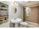 Charming bathroom with pedestal sink, glass enclosed shower, and decorative shelving at 1009 Monarch Way, Superior, CO 80027