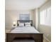 Cozy bedroom with a queen-size bed, side table, and ample natural light from two windows at 1009 Monarch Way, Superior, CO 80027