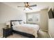 Cozy bedroom with a ceiling fan, plush carpet, and a queen-size bed with dark wood accents at 1009 Monarch Way, Superior, CO 80027