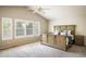 Serene bedroom with a vaulted ceiling, neutral tones, large window, and wood-paneled bedframe at 1009 Monarch Way, Superior, CO 80027