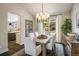 Elegant dining room featuring a modern chandelier, view to the backyard and ample natural light at 1009 Monarch Way, Superior, CO 80027