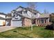 Charming two-story home with a well-manicured lawn, a two-car garage, and appealing architectural details at 1009 Monarch Way, Superior, CO 80027