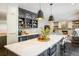 Modern kitchen with a large center island, stylish pendant lighting, and seamless flow into the living room at 1009 Monarch Way, Superior, CO 80027