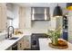 Bright kitchen featuring stainless steel appliances, white cabinets, and quartz countertops at 1009 Monarch Way, Superior, CO 80027