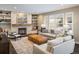 Cozy living room with a stone fireplace, a wooden mantel, recessed lighting, and a comfortable seating area at 1009 Monarch Way, Superior, CO 80027