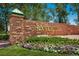 Landscaped entry sign for Rock Creek featuring beautiful flowerbeds and a stone structure at 1009 Monarch Way, Superior, CO 80027