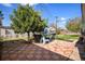 Backyard with tiled patio, shade tree with swing, and a privacy fence at 1910 S King St, Denver, CO 80219