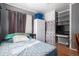 Bedroom featuring wood floors, built-in storage, and an abundance of natural light from a window at 1910 S King St, Denver, CO 80219